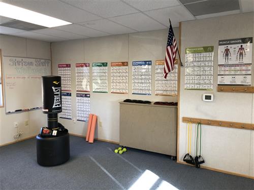 Staff wellness room at Stetson Elementary. Image description: a classroom with a punching bag, weights and other wellness eq.