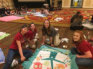 May Bombria (16), Fayth Smith (16), Kierstin Estepp (17), and Chai Bensenberg (17) stop to show the blanket they were making 