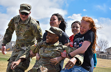  Picture of sand creek high school students carrying a soldier
