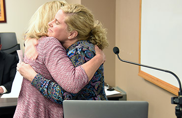  Sheehan Freeman-Todd, principal at MRES, congratulates Melinda Snavley during Fantastic 49.