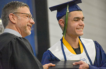 Picture of Liberty Tree Academy graduate receiving diploma