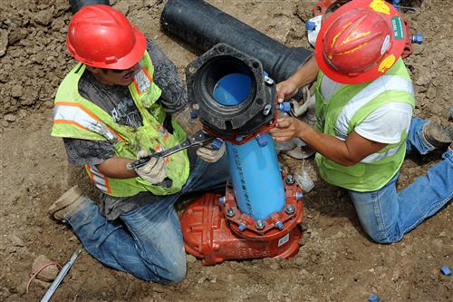 Facilities crew working on pipe 