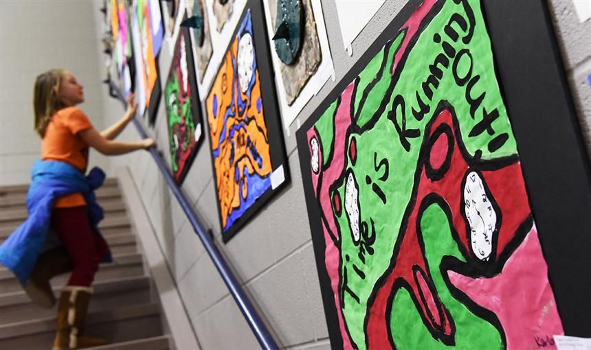  A student looks at art from other Sand Creek Zone students at the third annual art & design expo.