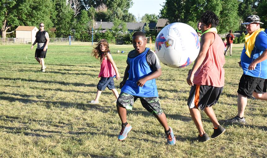 Karim Fudge, 10, sixth grader at BLRA, launches the ball into the air during "kick around." 