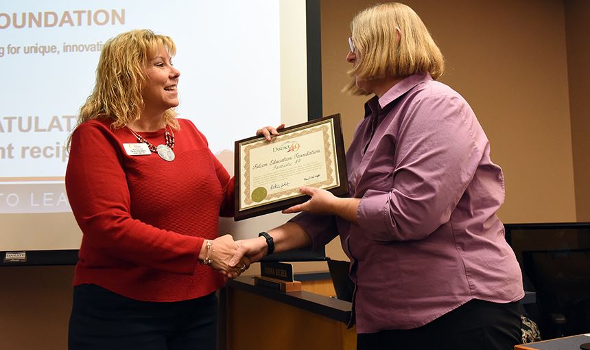  Sandi Esparsen receives a plaque of appreciation from Marie LaVere-Wright Nov. 9.