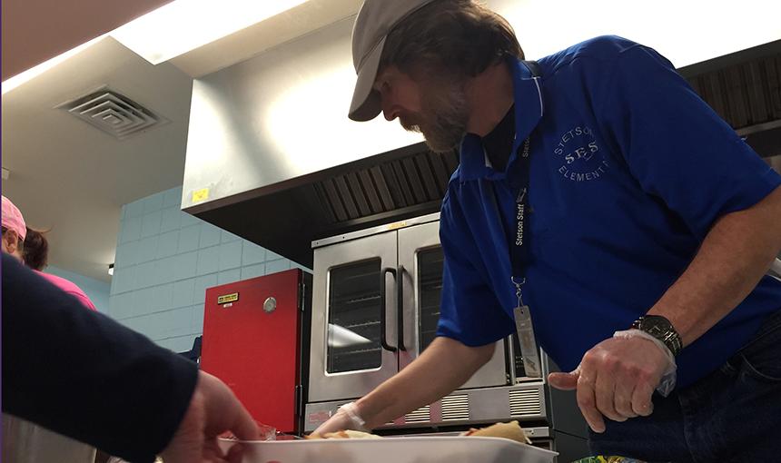  Mike Nowling, Stetson Elementary School art teacher, helps with lunch.
