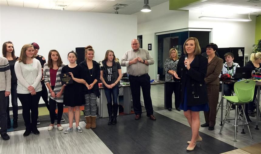 Springs Studio for Academic Excellence students receive an award from Care and Share.