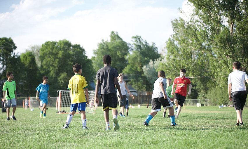  Players gather on the field behind Evans International Elementary School for Summer Soccer